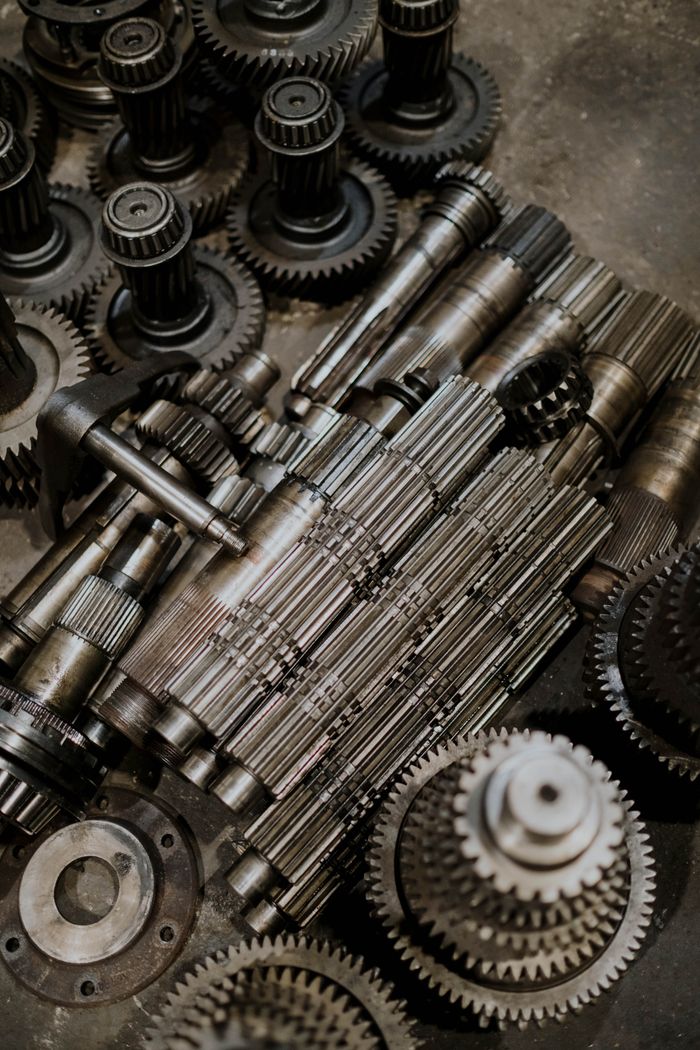 product-04 Close-up of metallic cogs and gears showcasing intricate machinery design for industrial use.